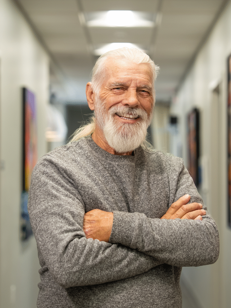 Dr. Heatrice's patient smiling in the hallway of the office